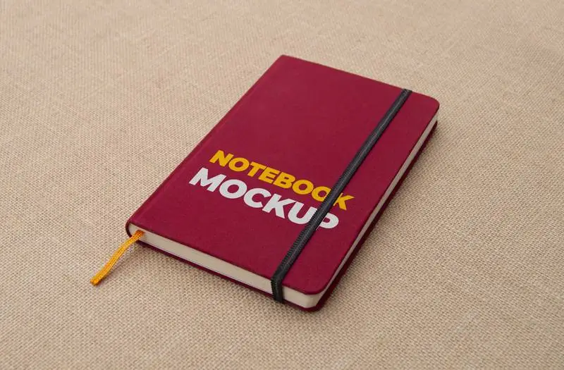 Red Notebook on Fabric Surface Mockup