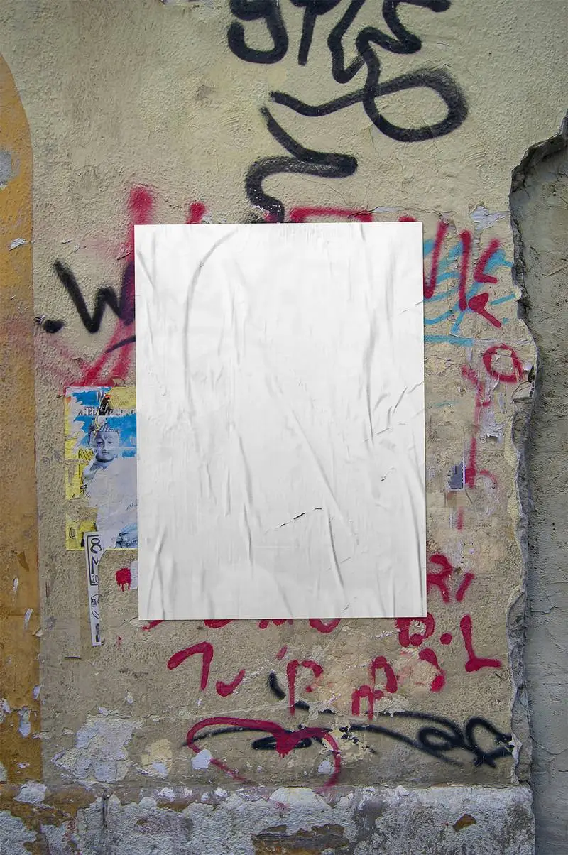 Crumpled Poster on Graffiti Wall