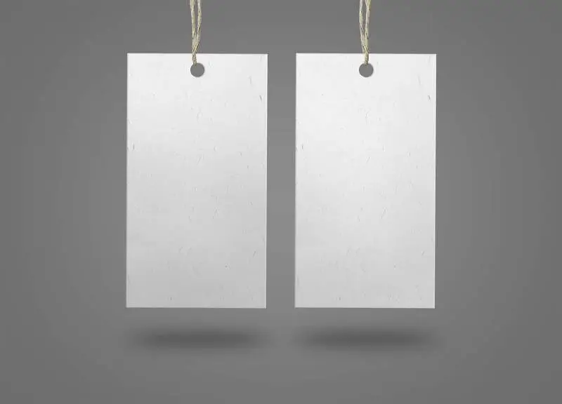 Two Paper Labels on Grey Surface
