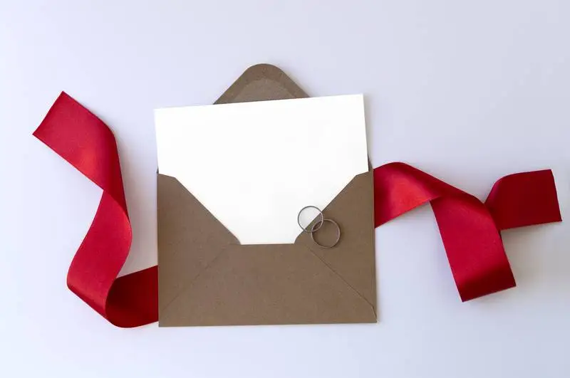 Envelope with Red Ribbon and Rings
