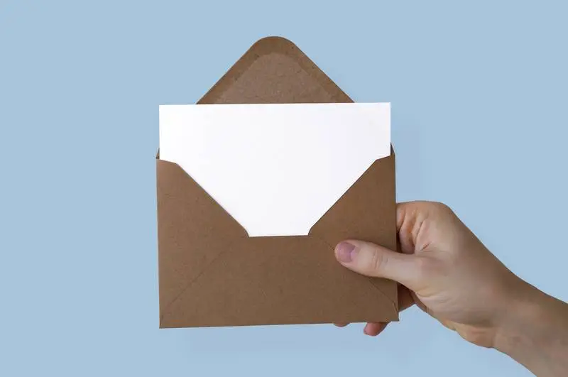 Enveloped Paper Held by Hand