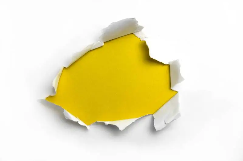 White Ripped Paper on Yellow Background