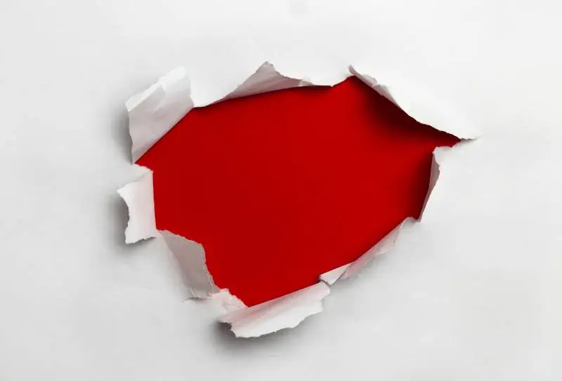 White Ripped Paper on Red Background
