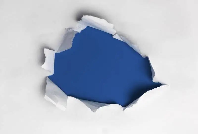 White Ripped Paper on Blue Background