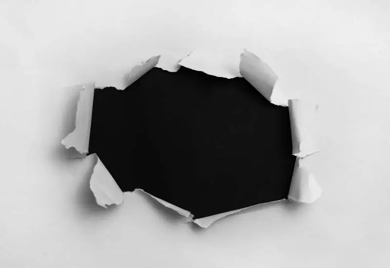 White Ripped Paper on Black Background