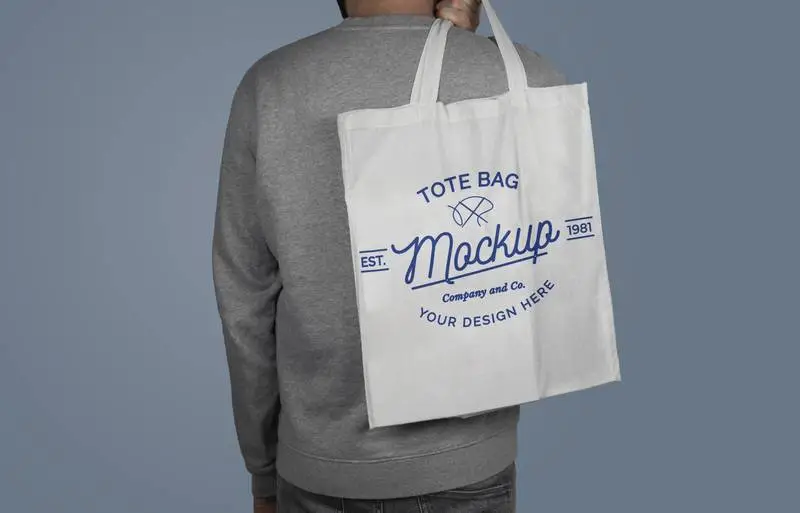 Mockup of Model Holding a Tote Bag on His Back