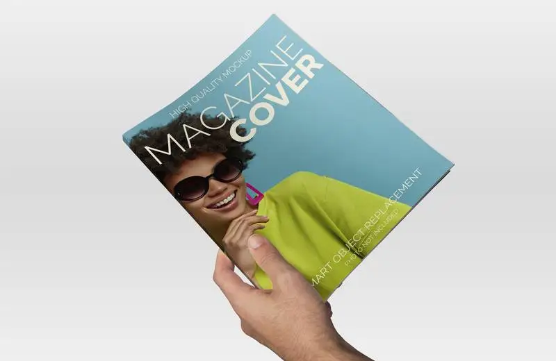 Mockup of Hand Holding a Magazine on a Light Background