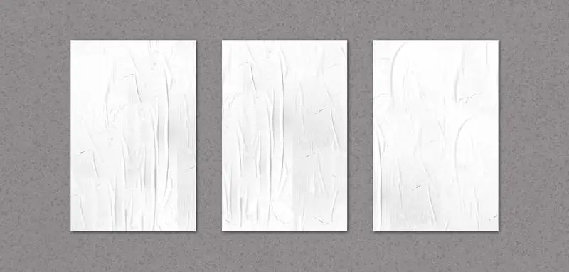 Isolated Collection of Crumpled Posters Over Concrete Wall