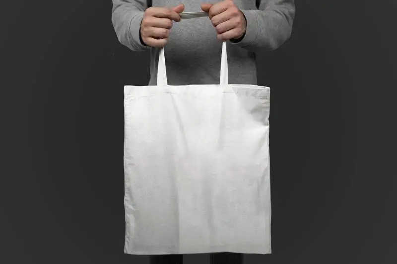 Image of a Model Holding a Blank Tote Bag
