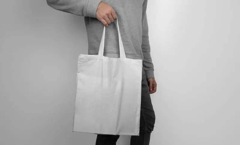 Model Holding a White Tote Bag