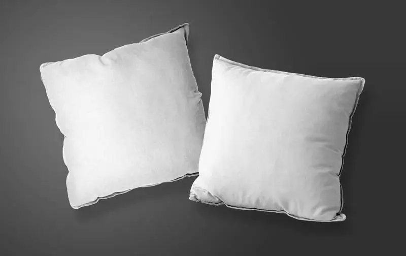 Pack of White Pillows Over Dark Background