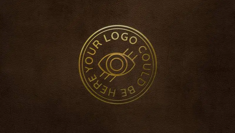 Mockup of Gold Pressed Logo on Brown Leather Background