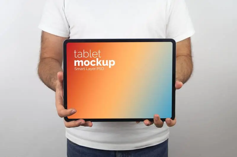 Mockup of Man Holding a Tablet Pro