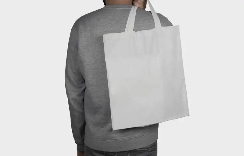 Model Holding a Tote Bag on His Back