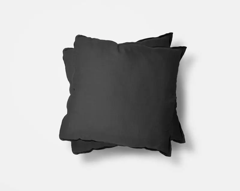 Two Black Cushions Over White Surface