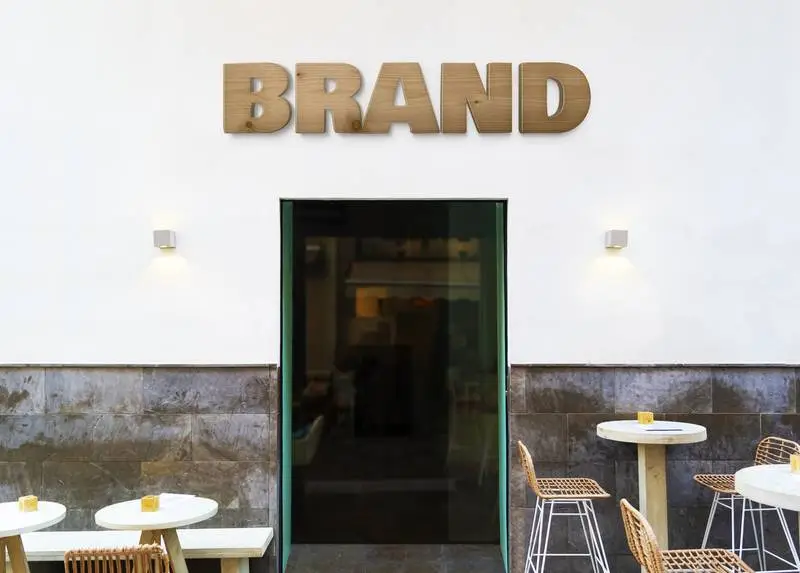 Mockup of Logo Made in Wood on a Wall of a Restaurant