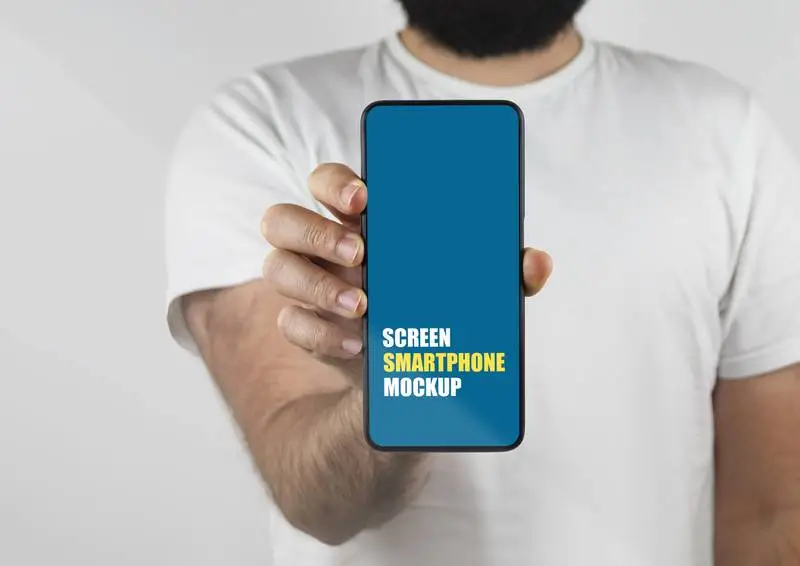 Mockup of a Man Holding a Smartphone Forward