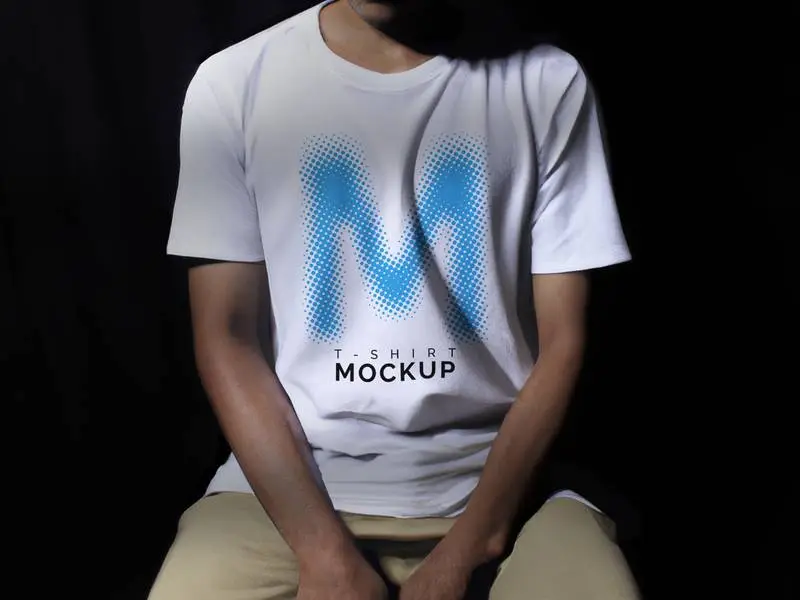 Mockup of Seated Indonesian Man in White T-Shirt