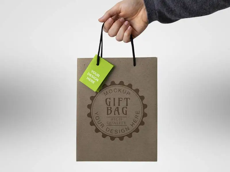 Mockup of Gift Bag with Label Held by Hand