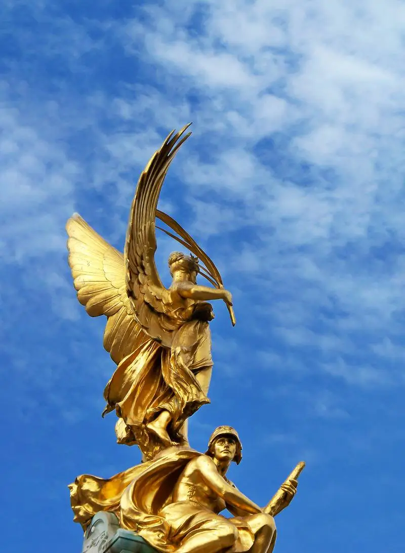 Photo of Classic Golden Sculpture with Sky in the Background