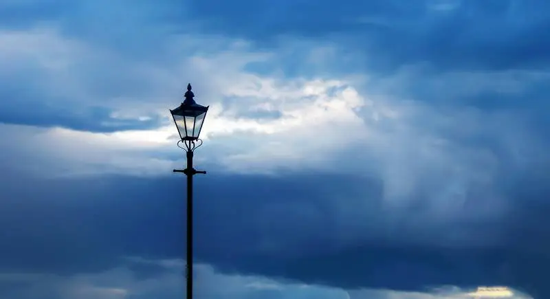Photo of Cloudy Sky at Dusk with Classic Streetlight