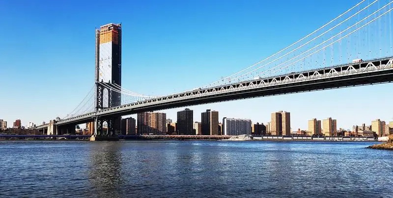 Photo of Bridge in New York with Building Under Construction in the Background