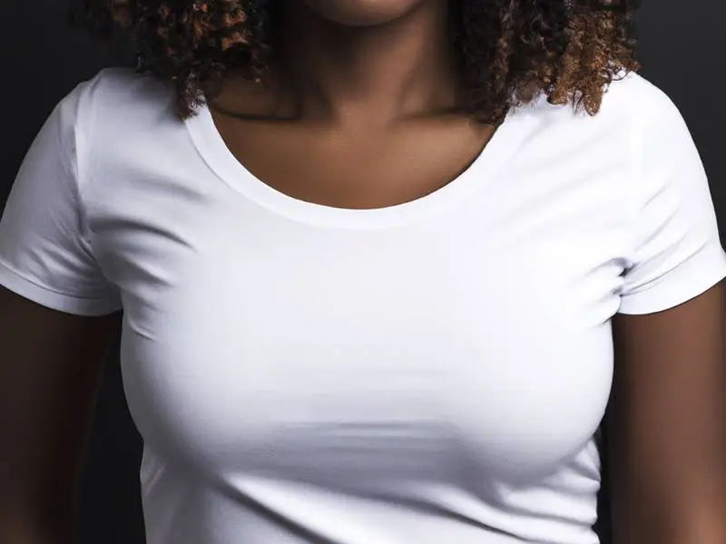 Black Woman Wearing White T-shirt on Dark Background