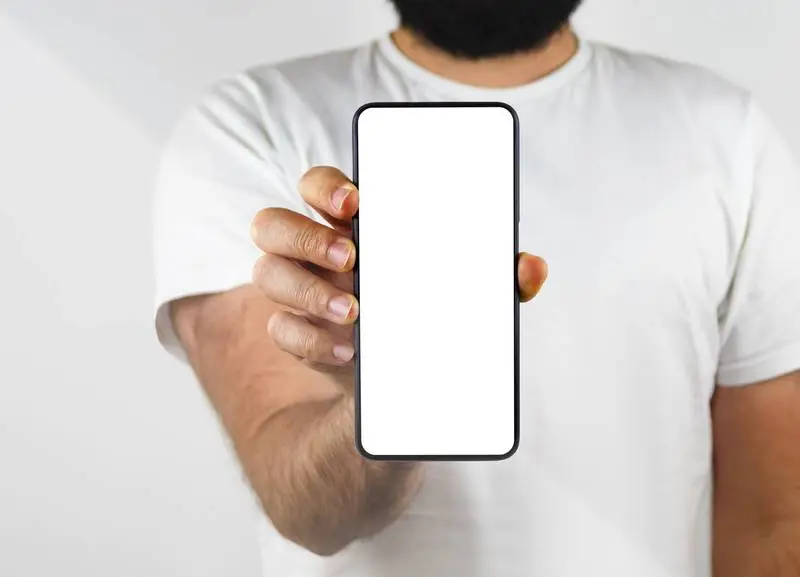 Man Holding a Smartphone in the Foreground on White Background