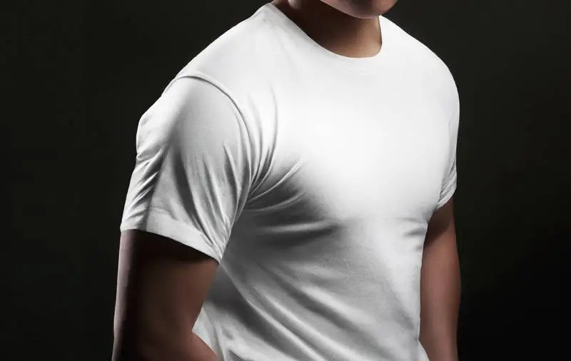 Man in Profile with White T-shirt on Dark Background