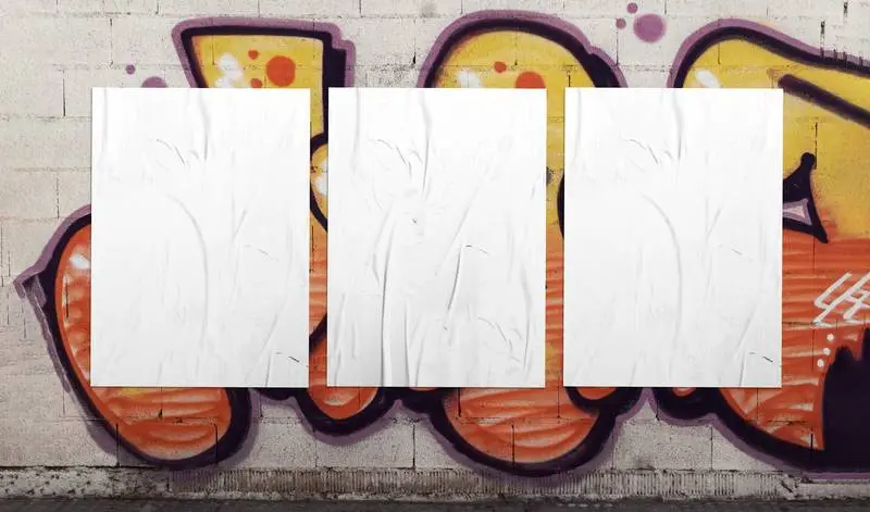 Three White Crumpled Posters Over Graffiti Wall