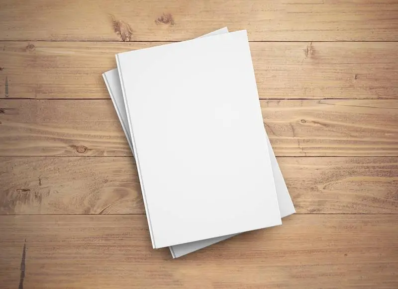 Two White Hardcover Books on Wooden Surface