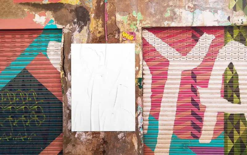 White Crumpled Poster on Grunge Graffiti Wall