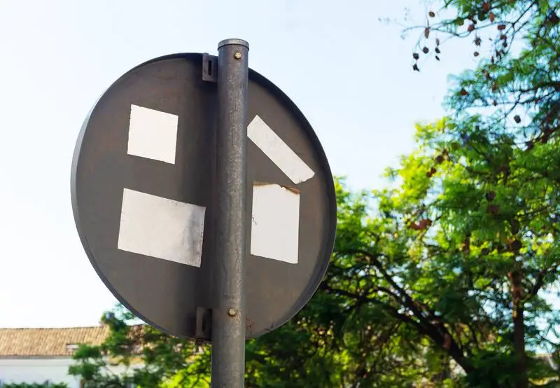 White Plain Stickers on the Back of a Traffic Sign