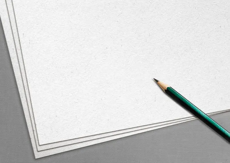 White Sheets with Pen Over Grey Surface