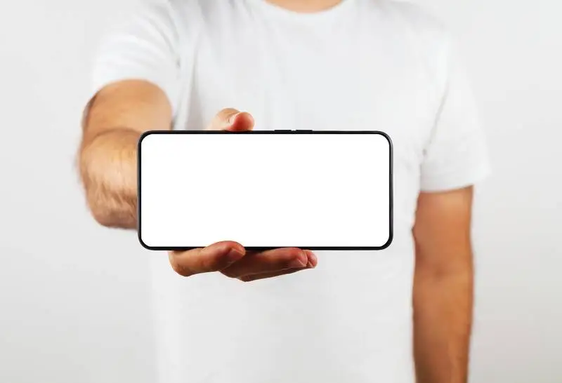 Model Holding a Plain White Smartphone on the Foreground