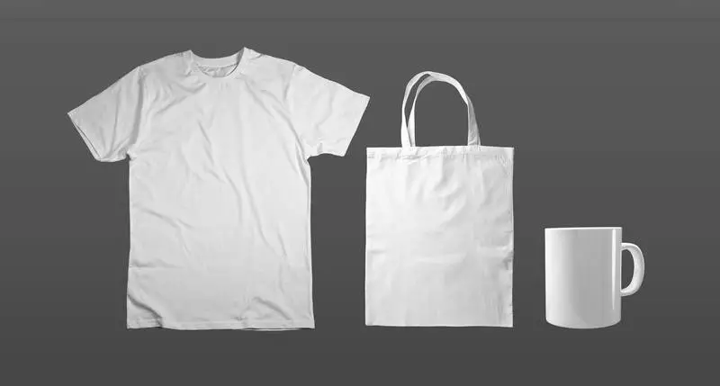 Set of White T-shirt, Tote Bag and Mug on Light Background