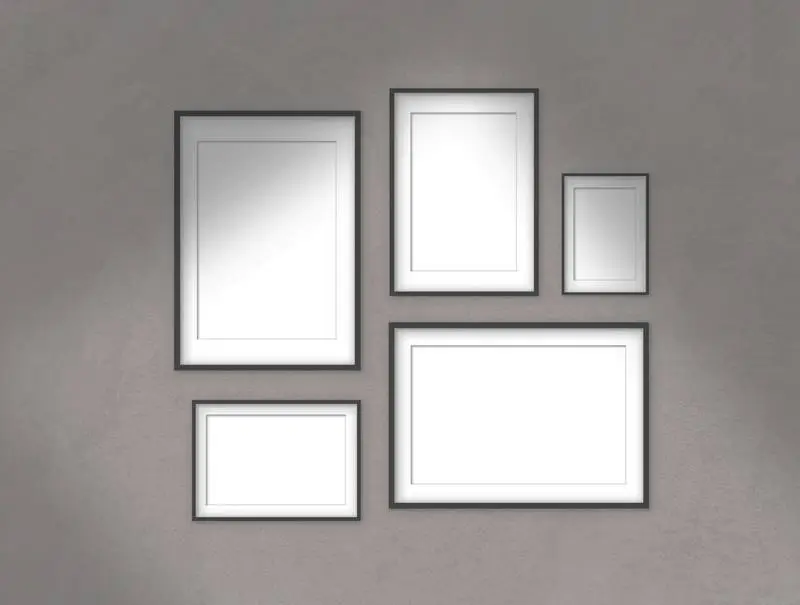 Collection of Black Frames Hanging on a Light Wall