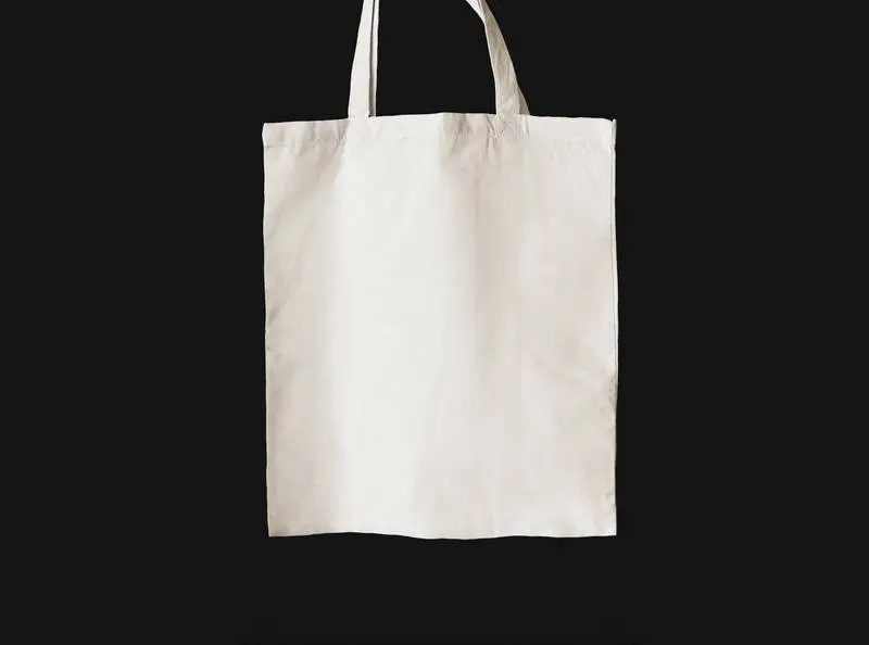 Plain White Tote Bag Hanging on Black Background