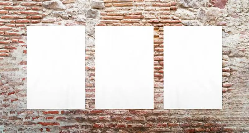Three White Posters in a Brick Wall