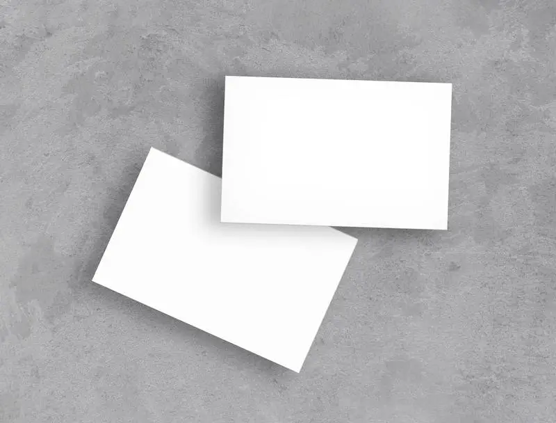 White Business Cards Over Concrete Surface