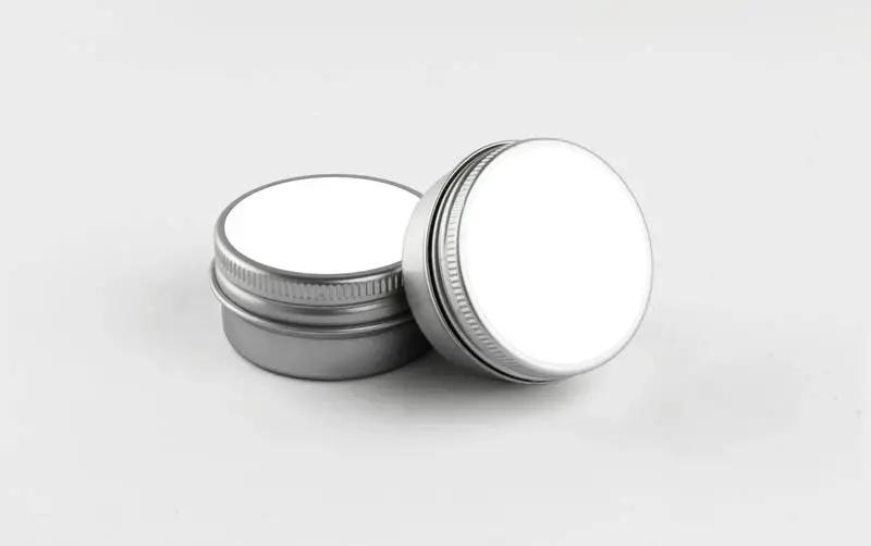 Pair of Round Metal Cosmetic Tins with White Label