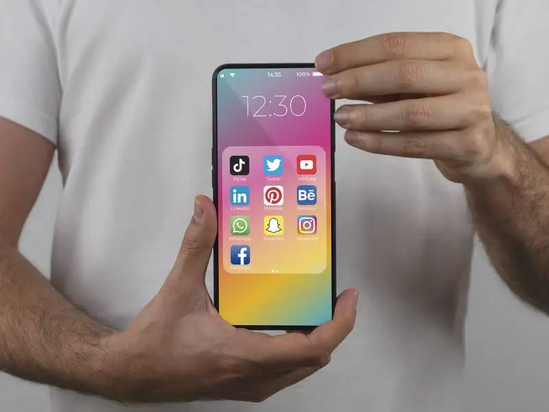 Mockup of a Smartphone in Vertical Position Held by a Person
