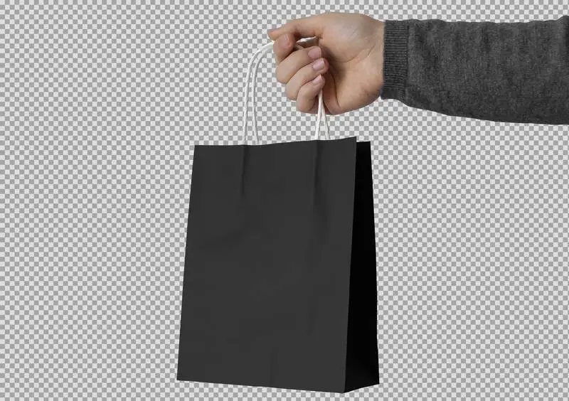 Hand Holding Black Paper Bag on Transparent Background