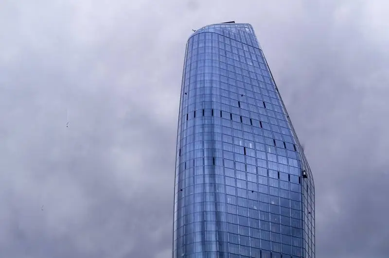 Modern Glass Building on a Cloudy Background