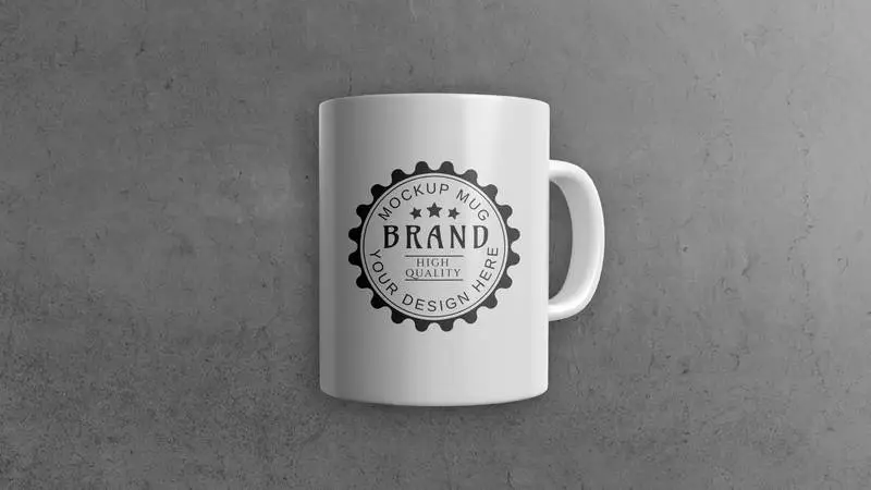 Mockup of a White Mug on a Grey Background with a Shiny Surface