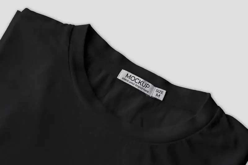 Mockup of Black T-Shirt Folded with White Label
