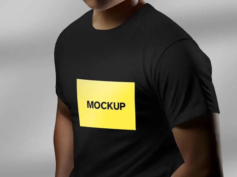 Mockup of a Model in Three-Quarter Stance Wearing a Black T-Shirt