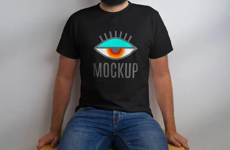 Mockup of Seated Model in Black T-Shirt