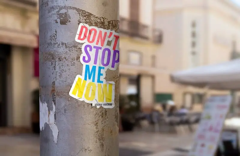 Mockup of Cracked Sticker Design on a Post