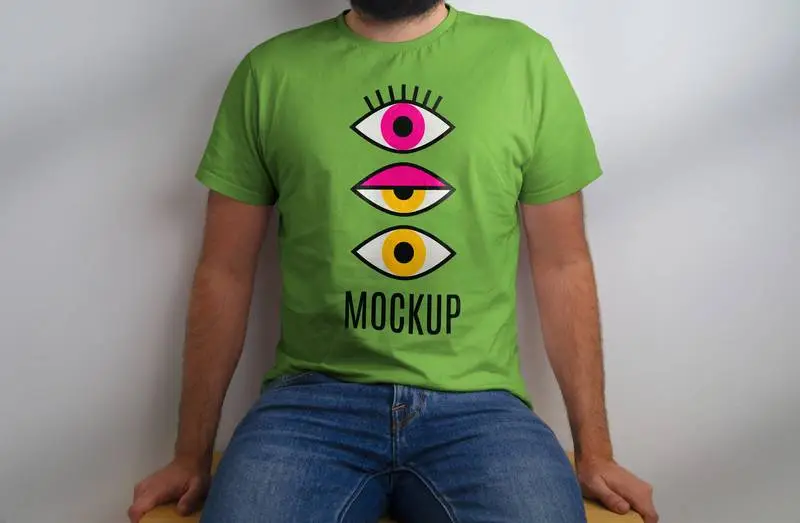 Mockup of Seated Model in Green T-Shirt